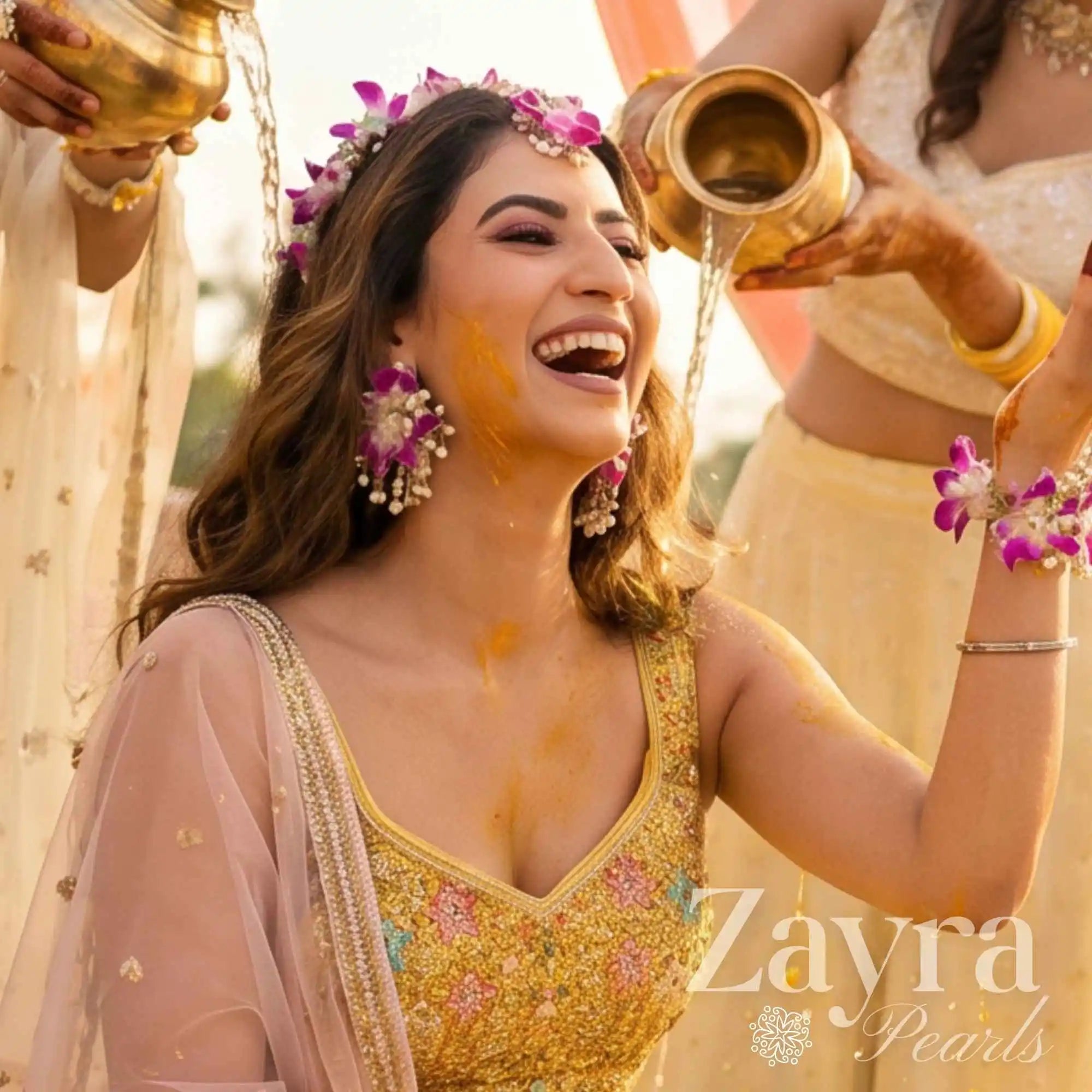 Bride smiling while wearing vibrant yellow floral bridal haldi jewlery and matching bangles