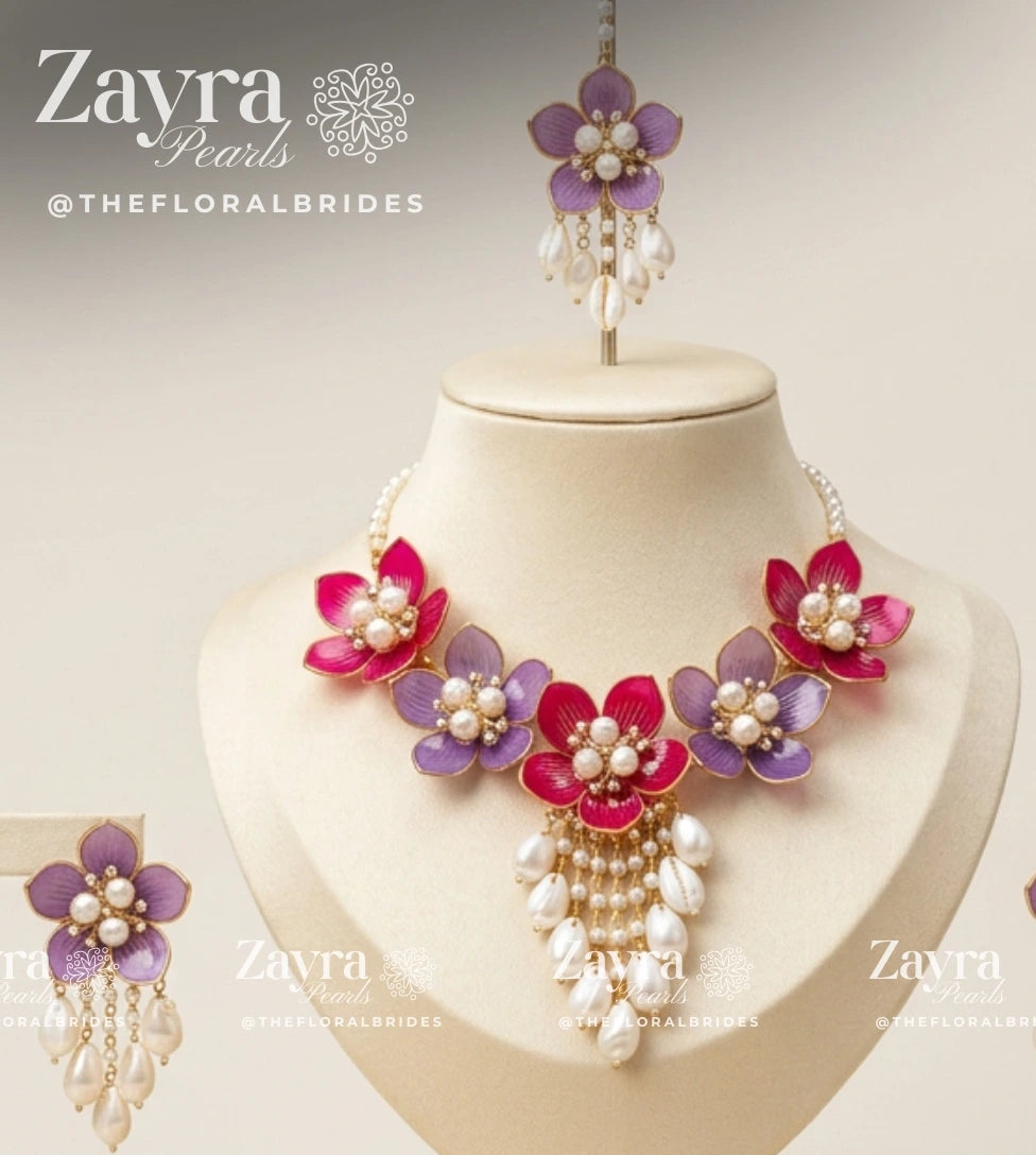 Close-up of cascading cowrie shell and resin petal necklace drops from the Berry Blossom Haldi Jewellery Set