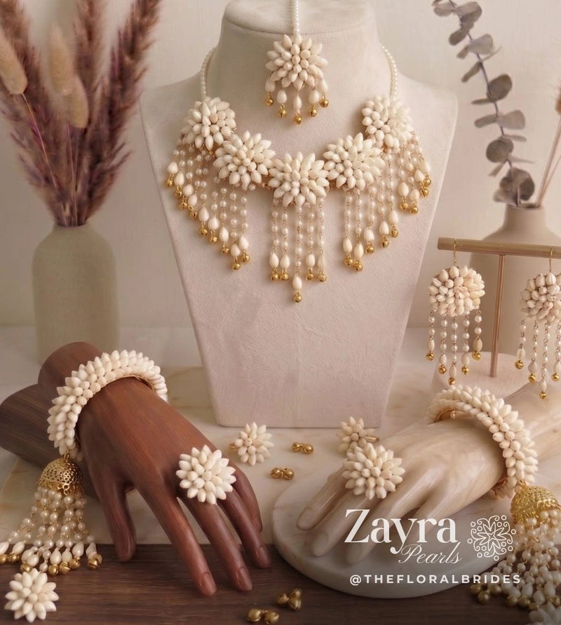 Full handcrafted premium white jasmine Mogra Floral Haldi-Mehndi set featuring a choker necklace, maangtikka, earrings with drops, finger rings, and kaleere bangles on display.with 'Zayra Pearls' branding.