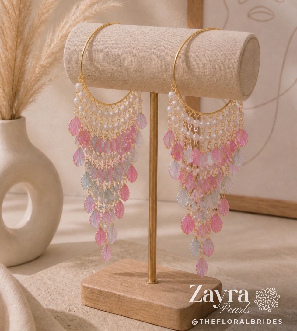 Pastel Haldi Bangles for Bride (Pair) | Zayra Pearls with pink and gold accents on a wooden stand, branded 'Zayra Pearls'.
