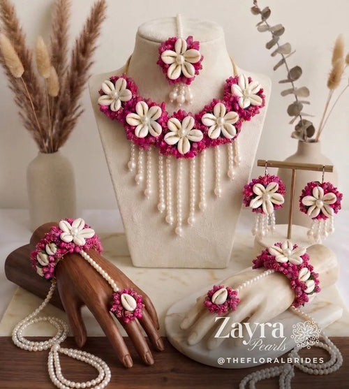 Zayra Pearls Baby Shower Floral Set featuring a fuchsia choker necklace, maang tikka, earrings, and dual hand harness haathphools.