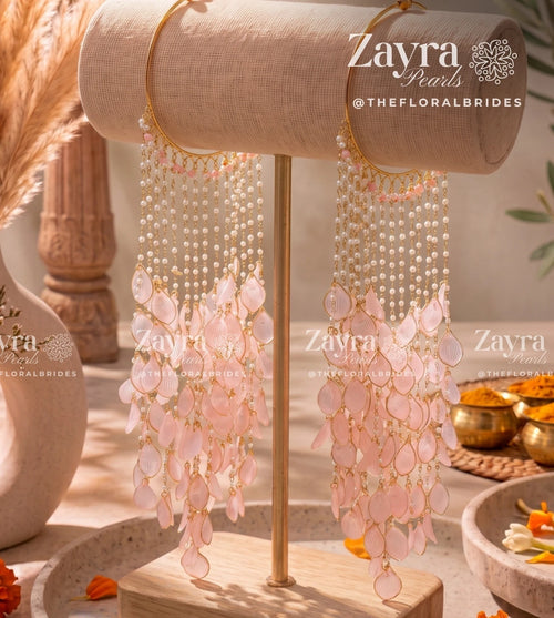 Handcrafted blush bloom haldi carnival kaleere with pink resin petals and pearl tassels by Zayra Pearls.