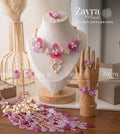 Handcrafted pink and purple floral viral haldi jewelry set with necklace earrings hathphool maangtikka and kaleere by Zayra Pearls.
