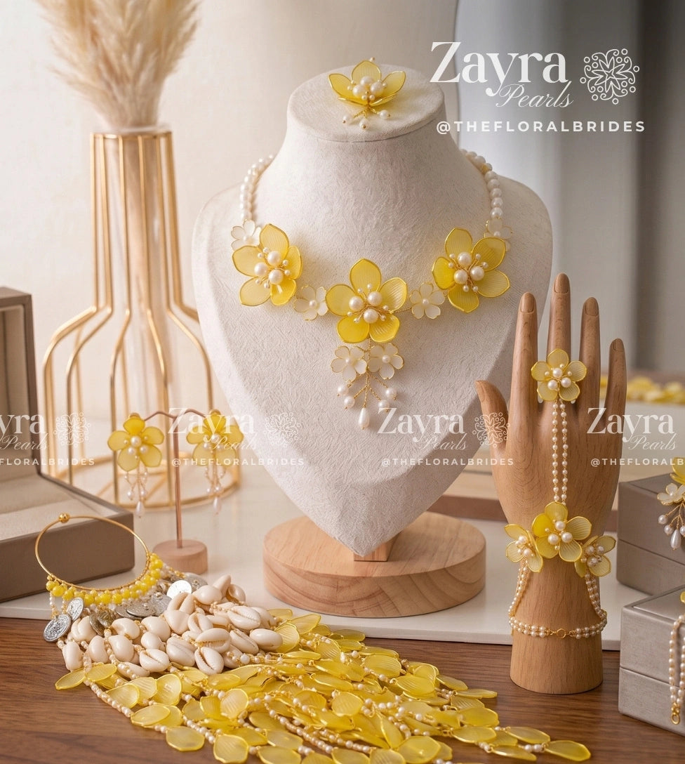 Handcrafted yellow floral Citrus Bloom viral haldi mehendi bridal set with necklace earrings hathphool maangtikka and kaleere by Zayra Pearls.