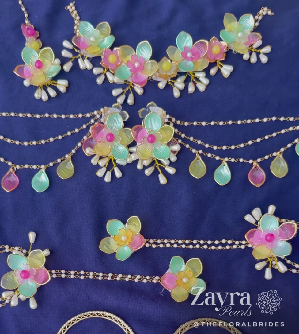 Zayra Pearls Pastel Bloom premium bridal jewellery set featuring translucent mint, pink, and yellow resin flower petals with delicate pearl strings, displayed haldi mehendi bridal jewellery