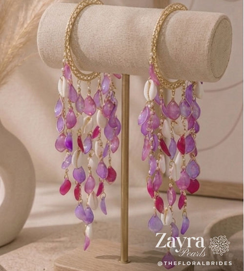 Zayra Pearls Bohemian Orchid sea shell Haldi bangels featuring a gold-toned base with cascading translucent violet and fuchsia petals and natural white cowrie shells